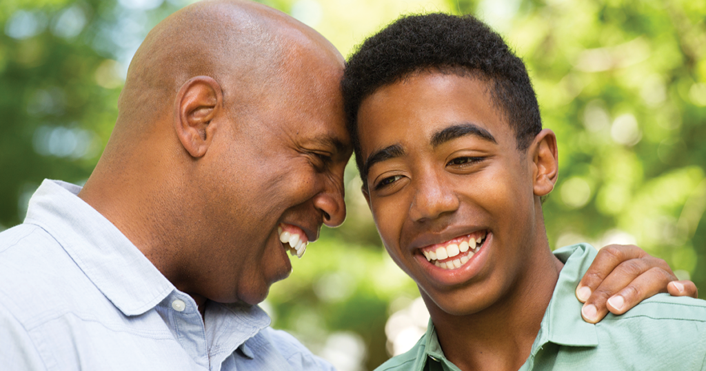 Father and son smiling